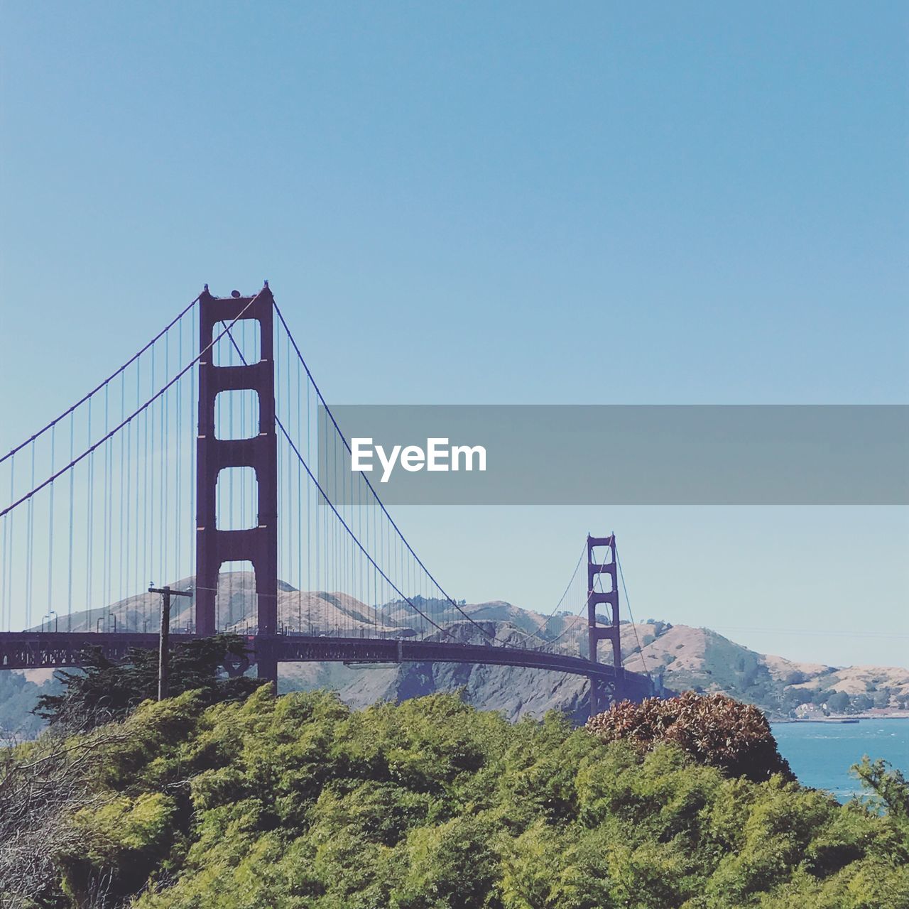 View of suspension bridge against clear sky