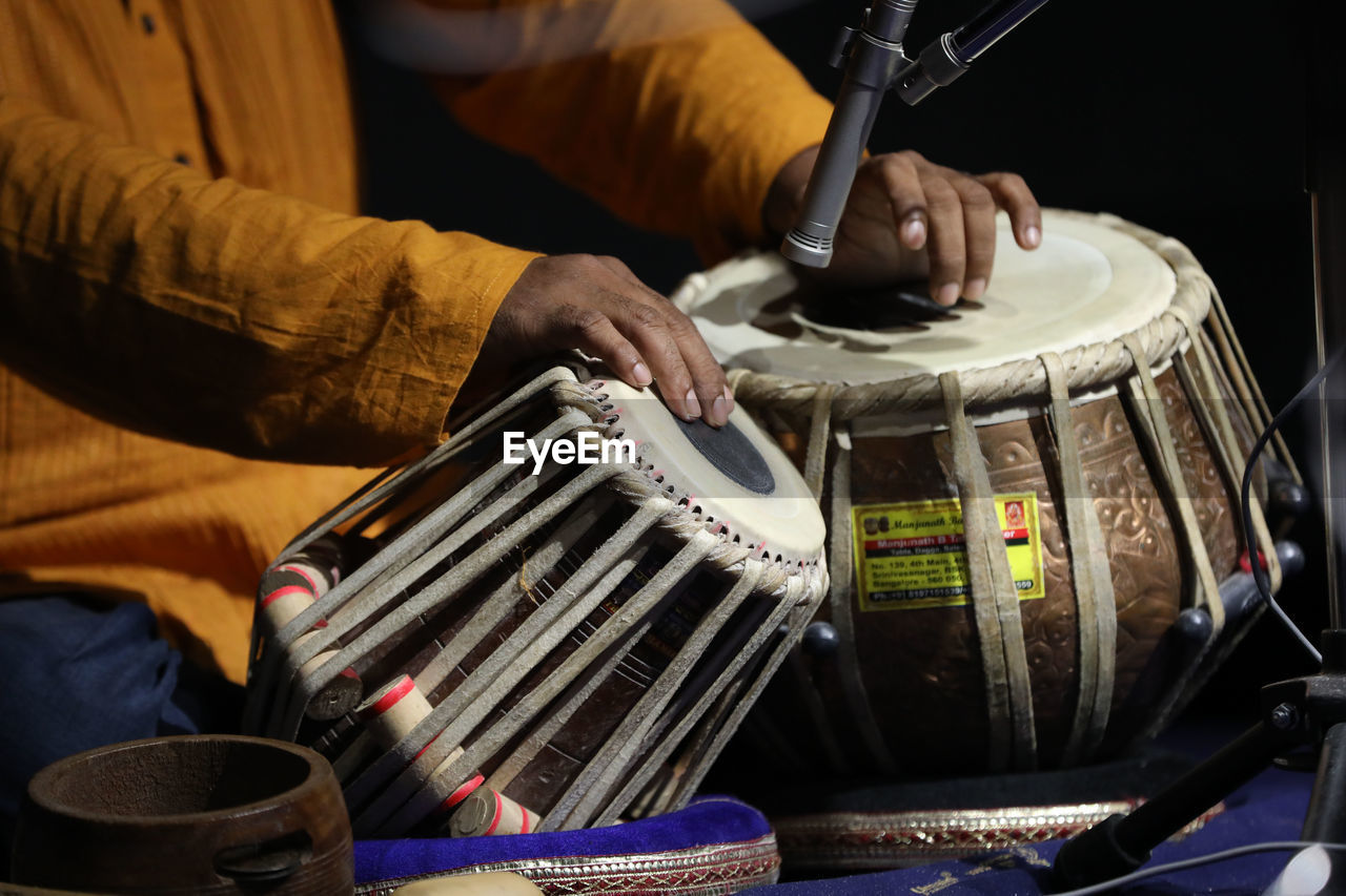 drum, percussion, one person, music, membranophone, drums, arts culture and entertainment, adult, drummer, musical instrument, musician, musical equipment, midsection, men, skill, hand, occupation, indoors, performance