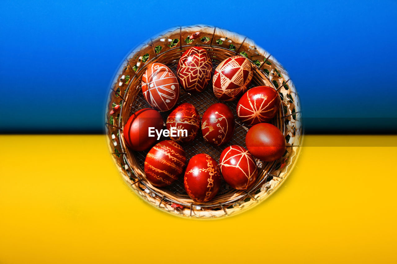 Basket of colored red eggs. easter holiday concept. ukraine flag. pysanka or krashanka.