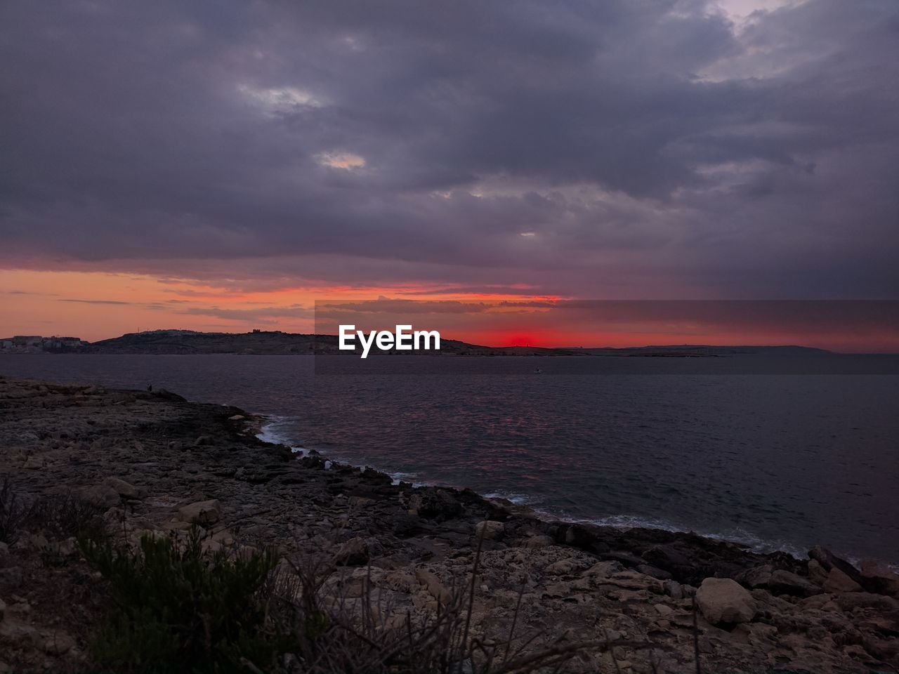 Scenic view of sea against sky at sunset