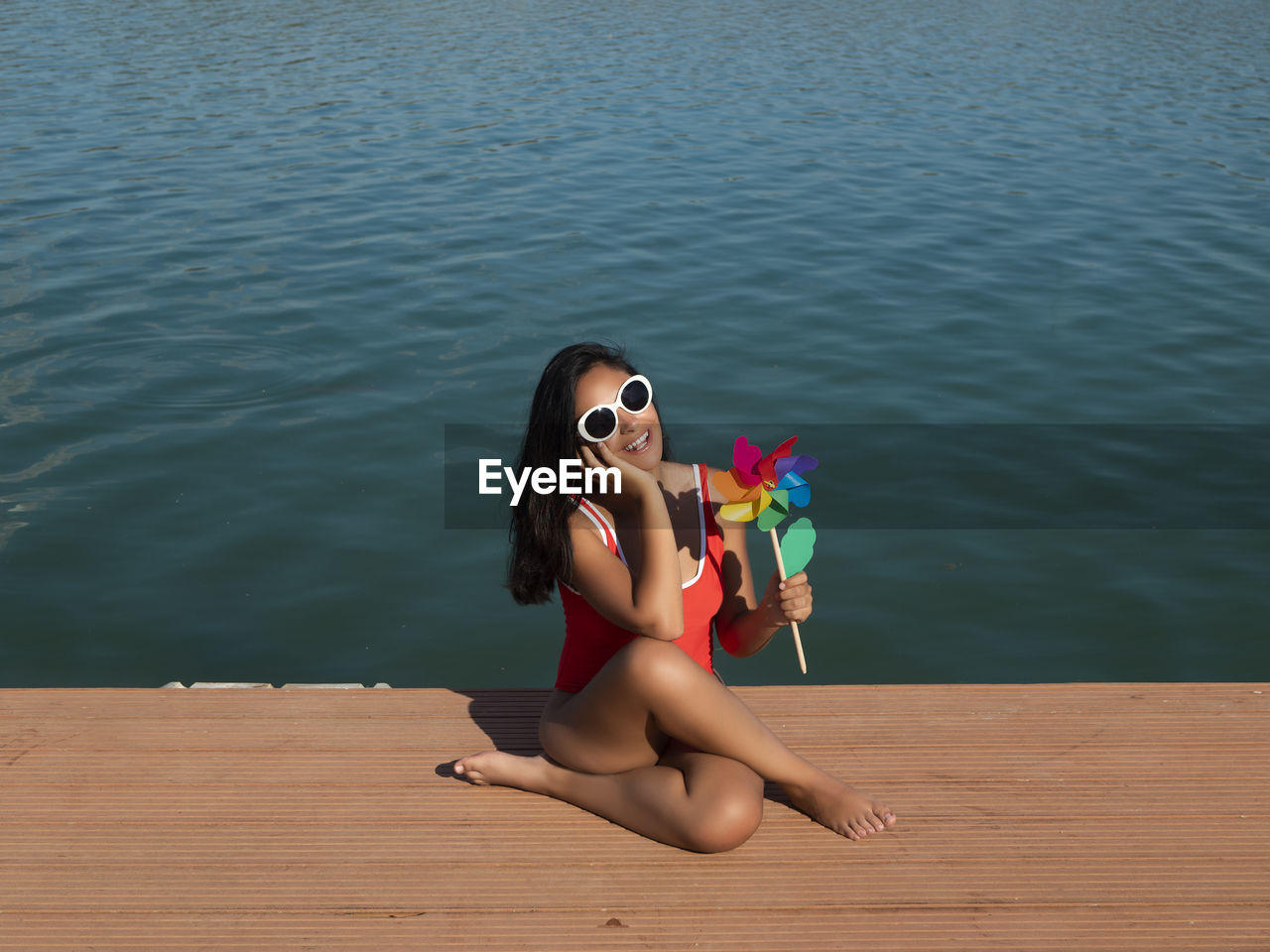 Side view of woman sitting on beach