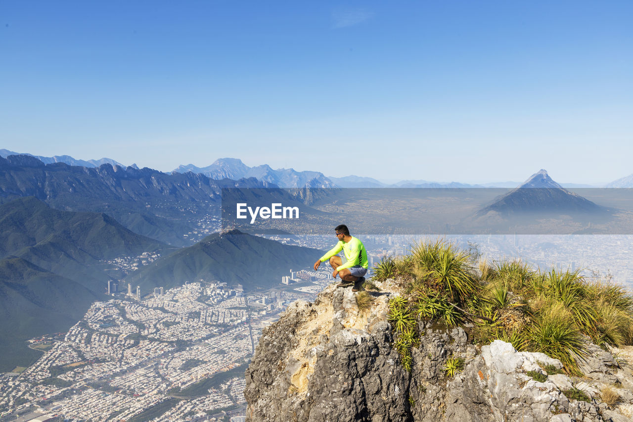 rear view of man standing on mountain