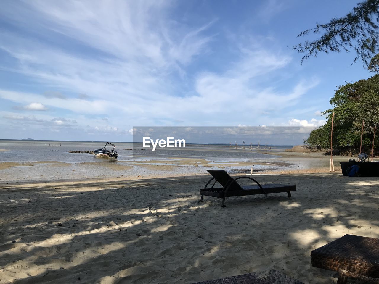 Scenic view of beach against sky and abandoned boat