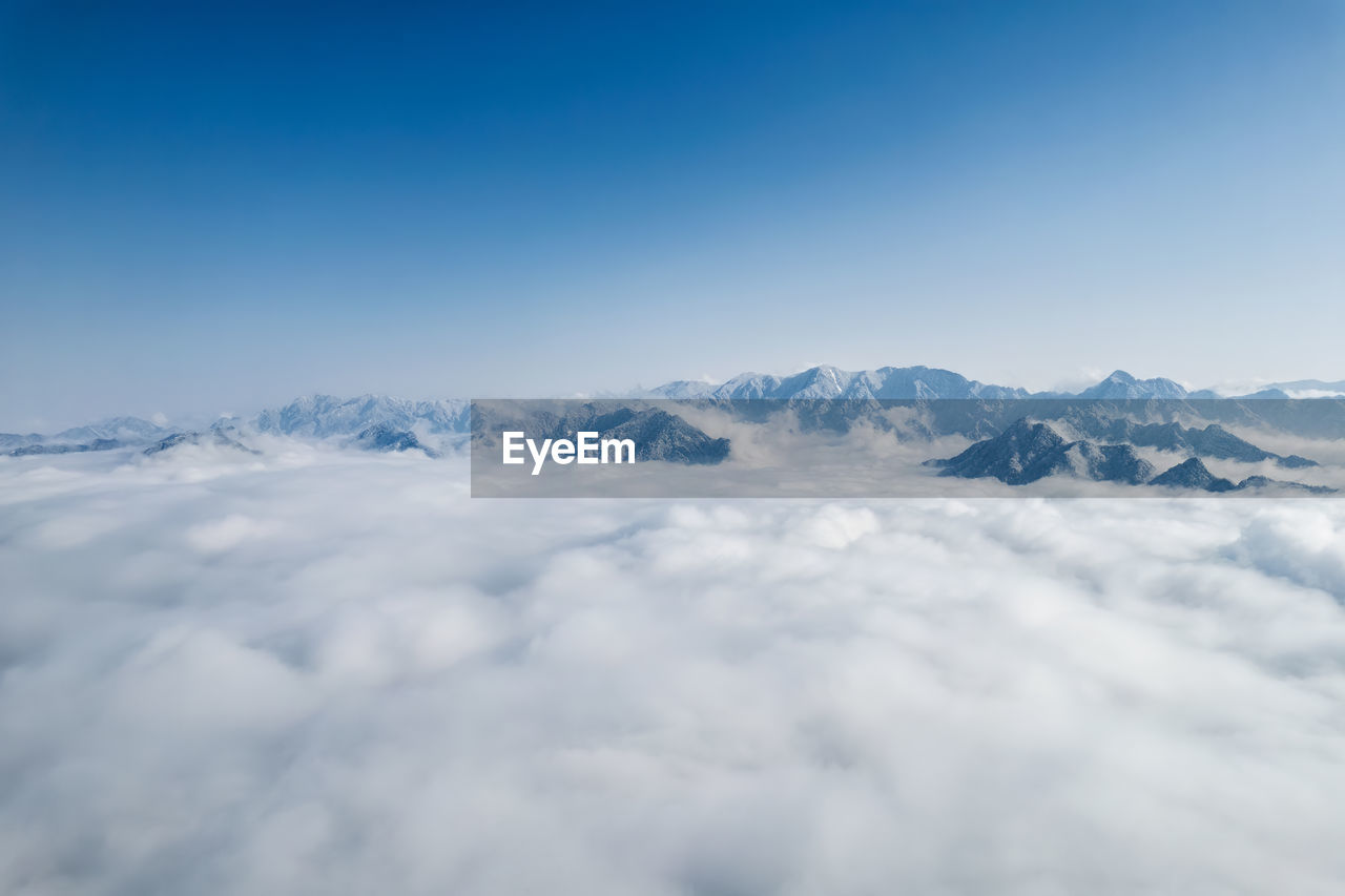 Low angle view of snowcapped mountains against sky