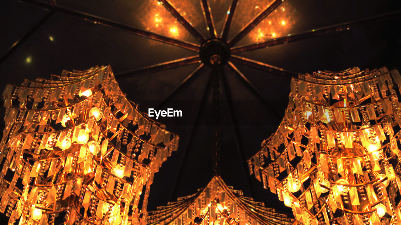 LOW ANGLE VIEW OF ILLUMINATED CHANDELIER