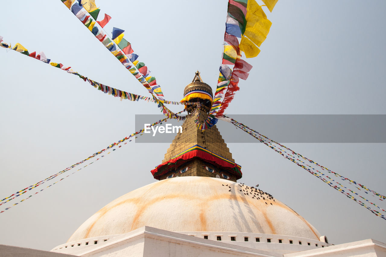 Low angle view of colorful prayer flags at bodnath stupa
