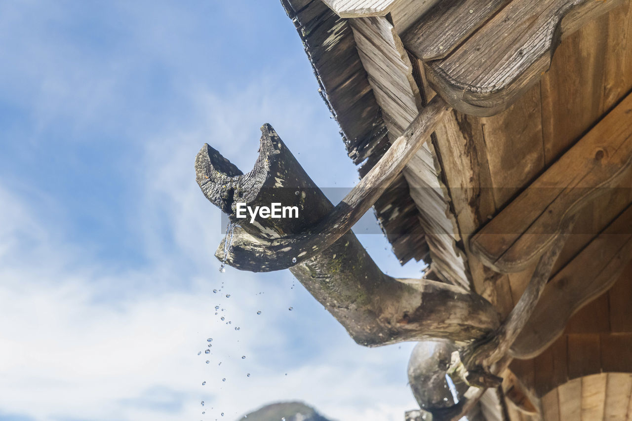 Old wooden gutter in an alpine village