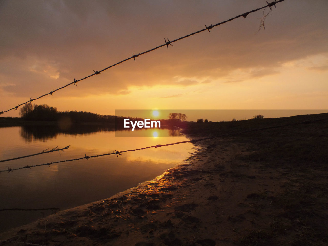 Scenic view of lake against sky during sunset