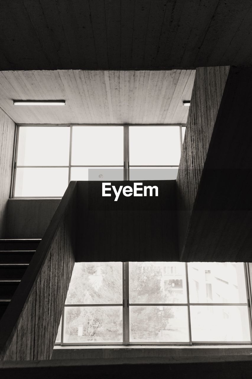 LOW ANGLE VIEW OF BUILDING SEEN THROUGH WINDOW