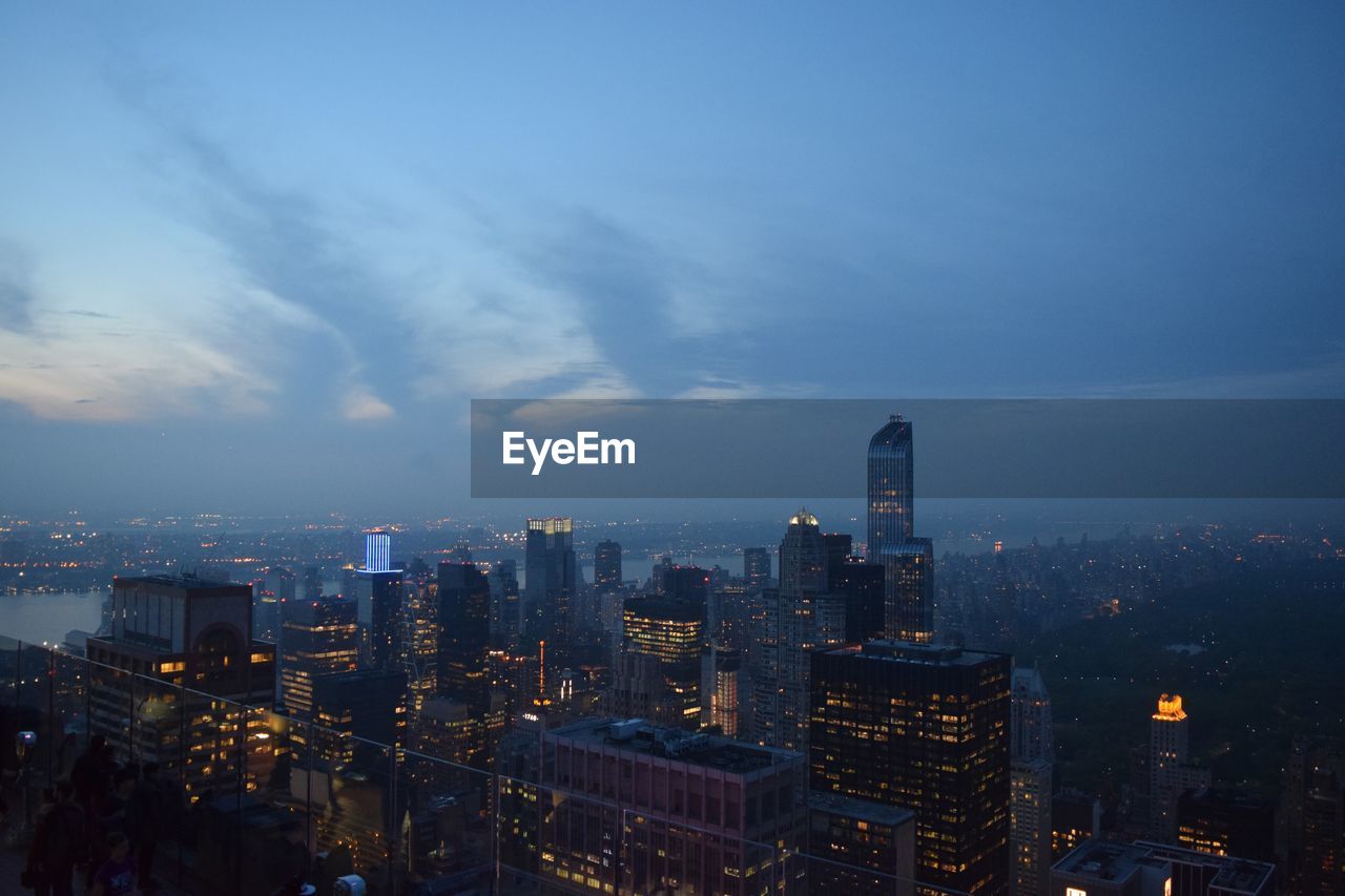 Illuminated cityscape against sky at night