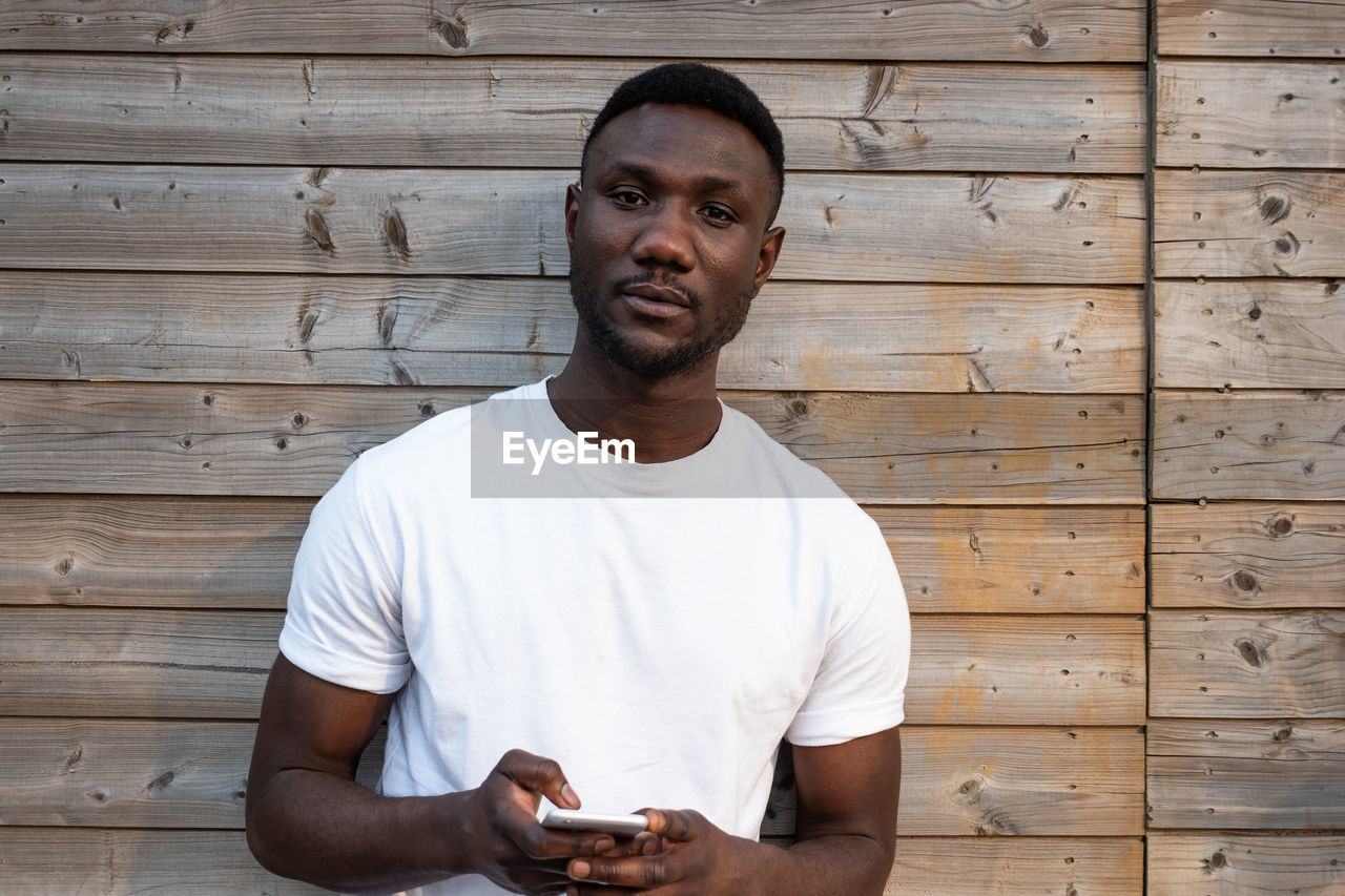 YOUNG MAN LOOKING AT CAMERA