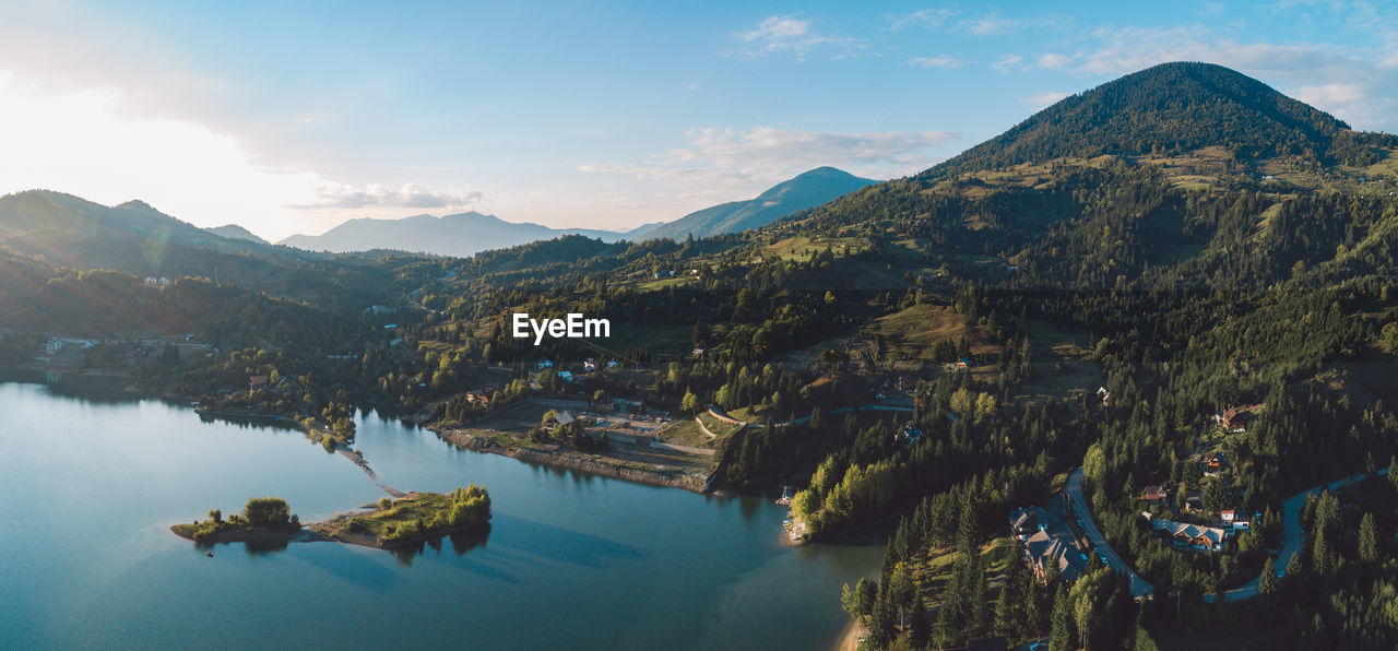 Scenic view of lake and mountains against sky