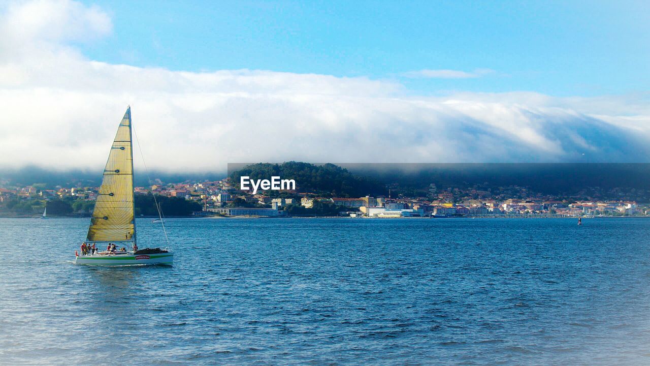 View of cityscape against cloudy sky