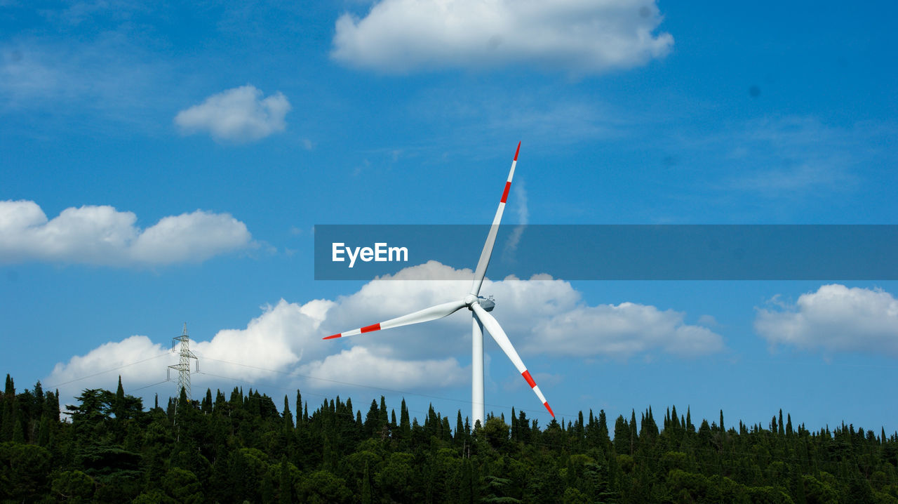 Low angle view of windmill against sky