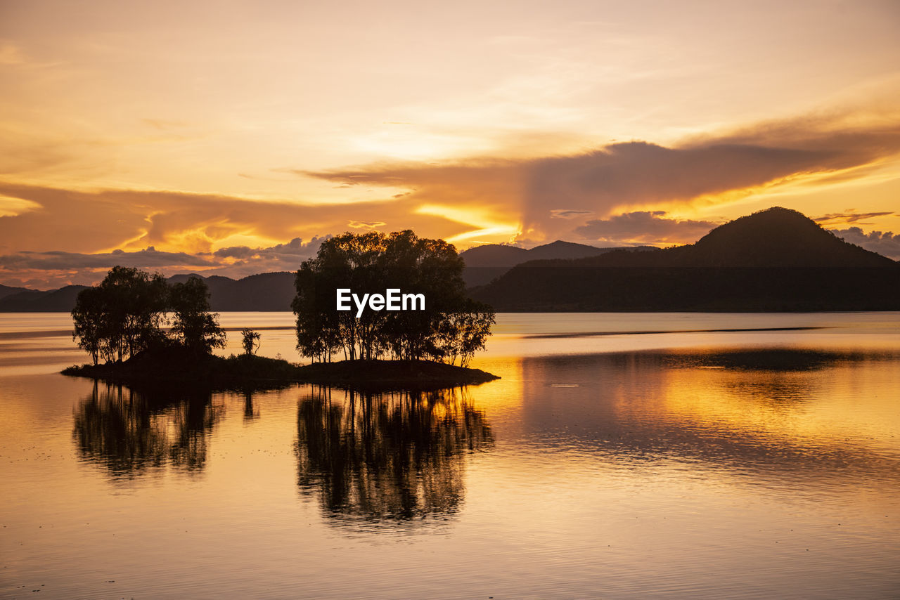 scenic view of lake against orange sky