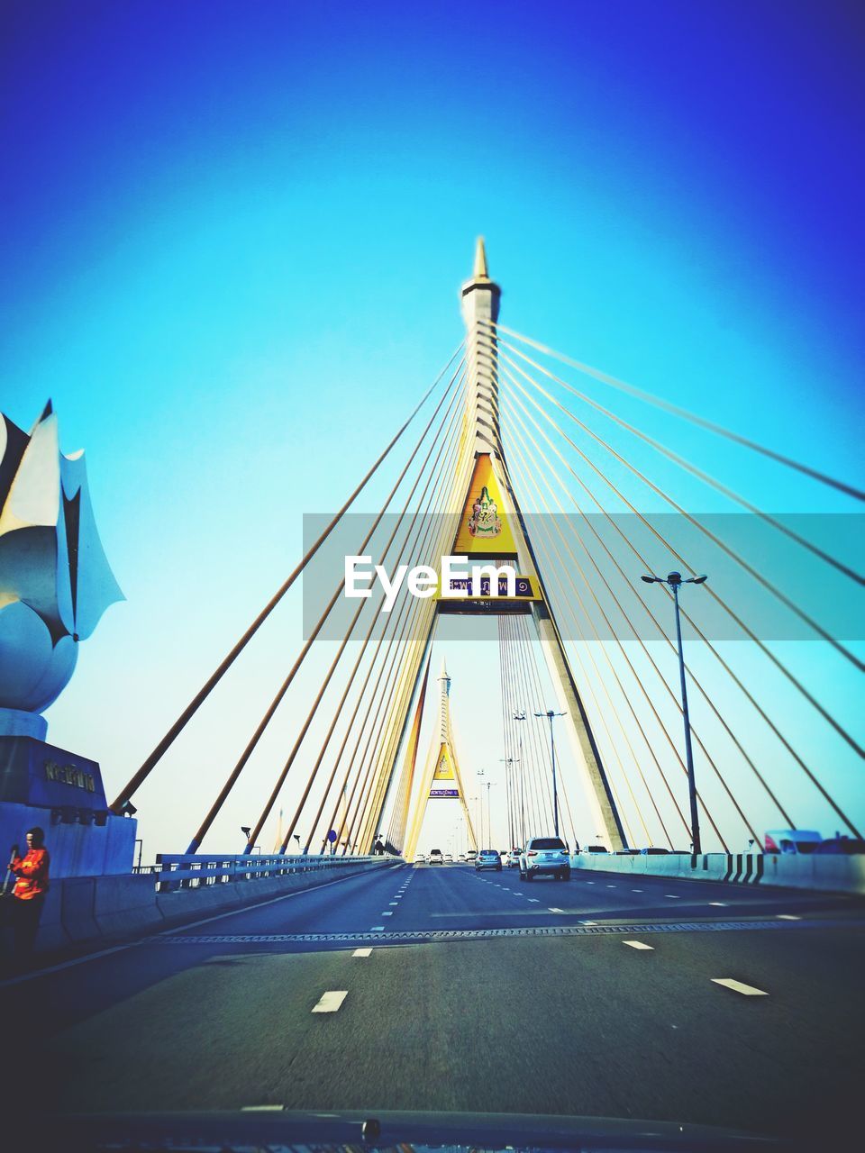 View of suspension bridge against clear blue sky