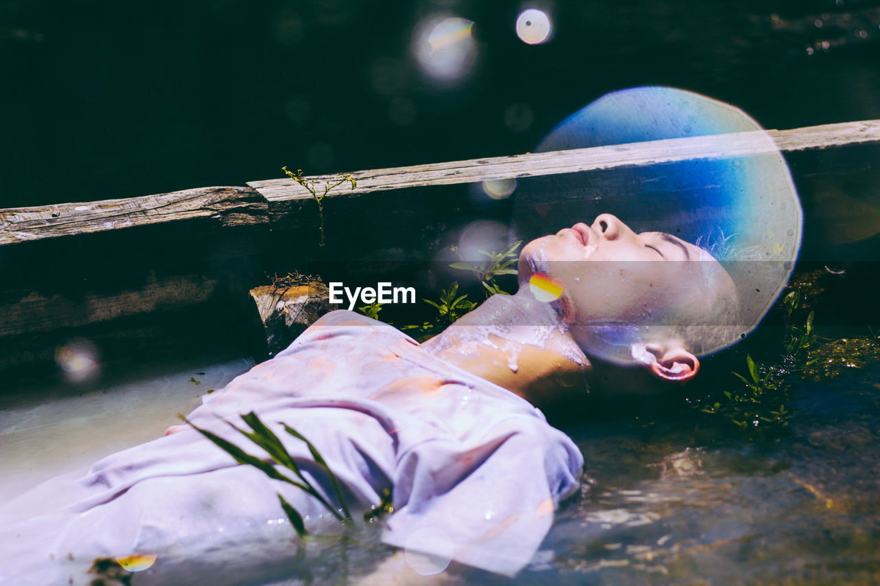 Digital composite image of man lying in water