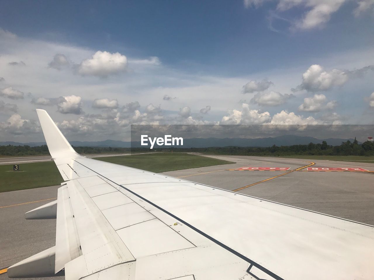 AIRPLANE FLYING OVER RUNWAY