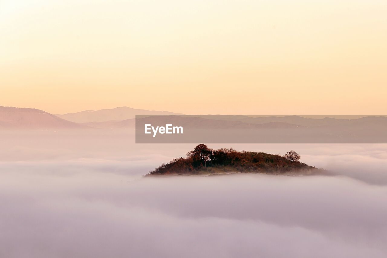 Scenic view of mountains against sky at sunset