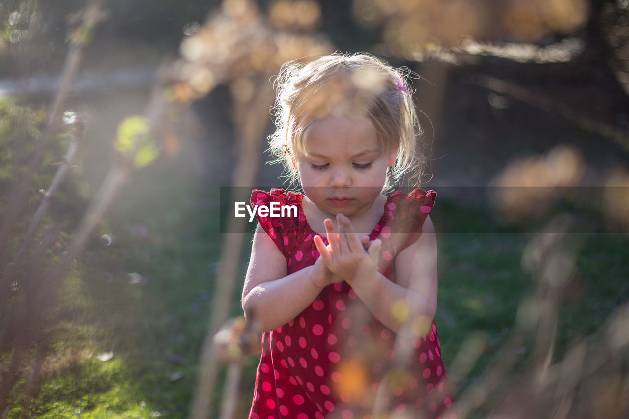 Cute girl standing at backyard
