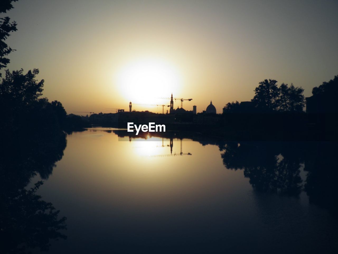 Scenic view of river with reflection during sunset