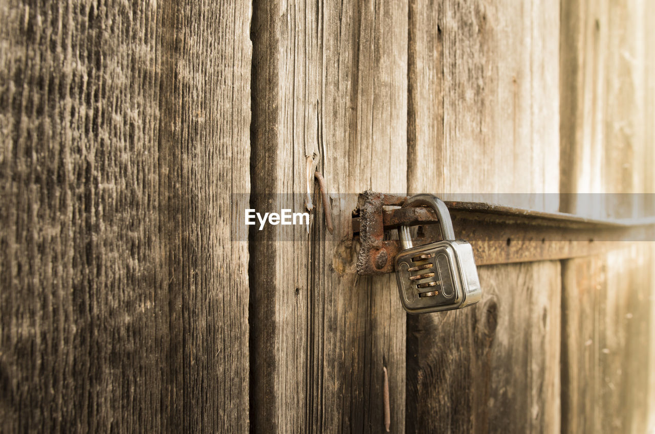 Close-up of padlock on wooden door