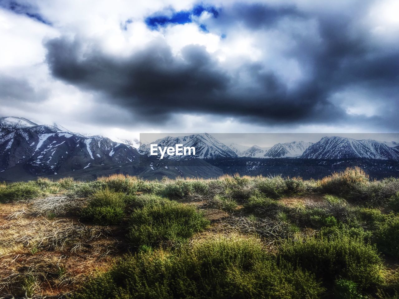 SCENIC VIEW OF MOUNTAINS AGAINST CLOUDY SKY