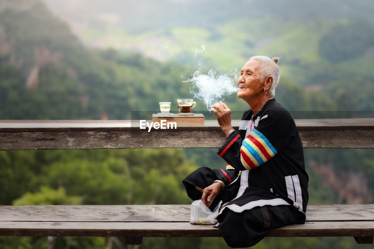 Full length of man sitting on bench