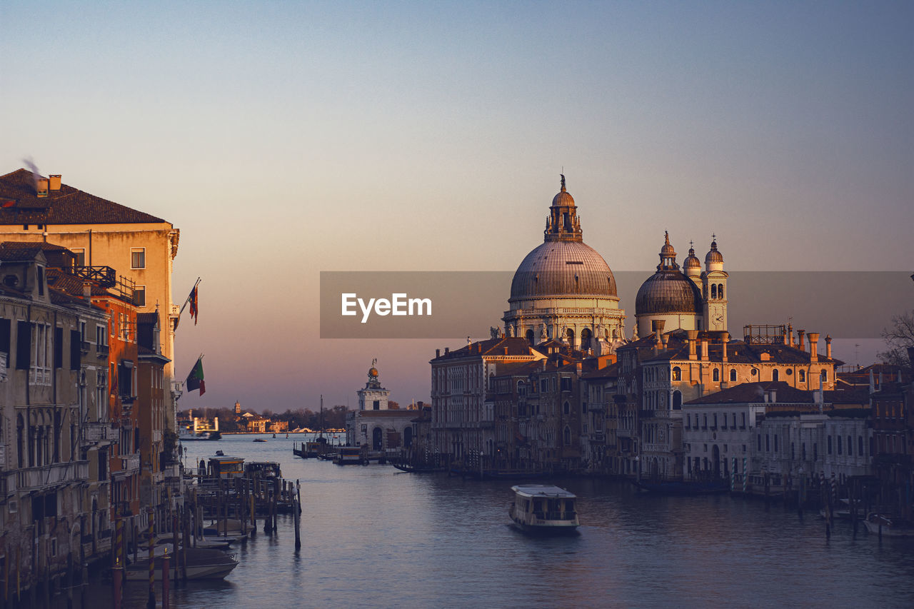 View of the canal grand and basilica of santa maria della salute from the accademia bridge at sunset