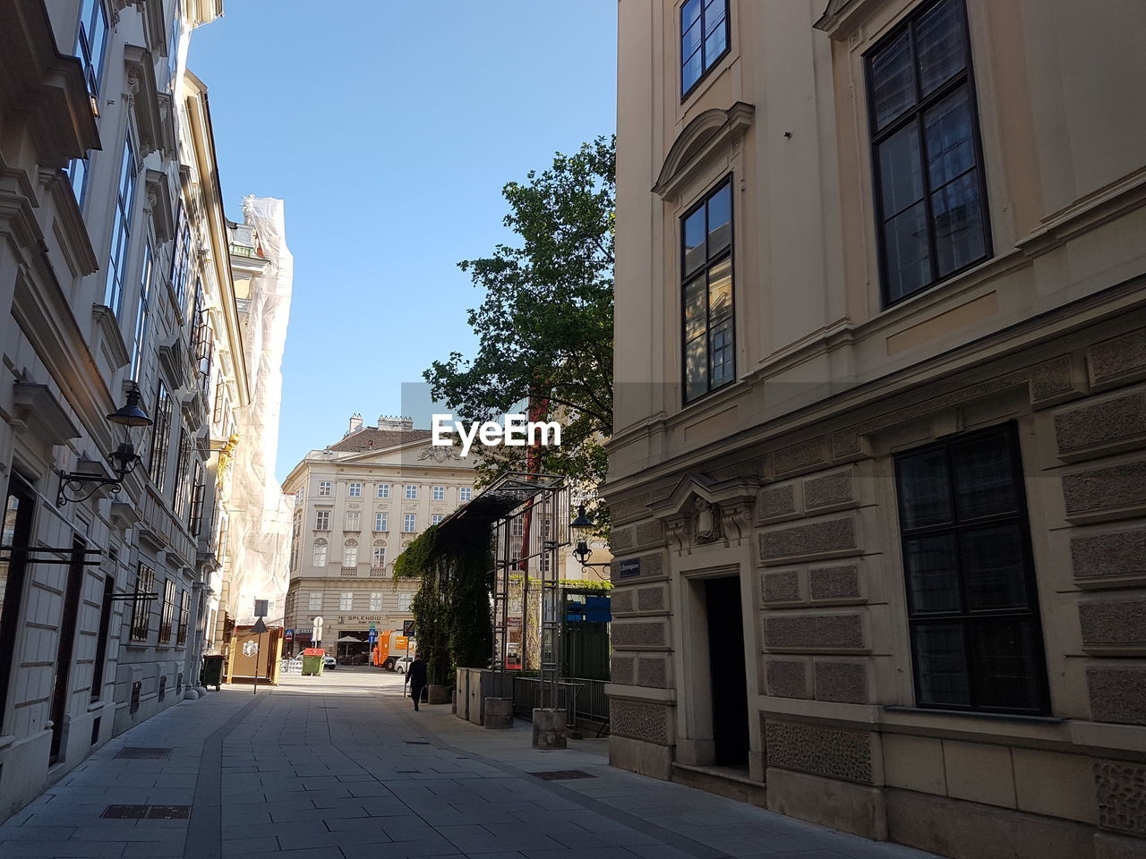 Street amidst buildings in city against clear sky