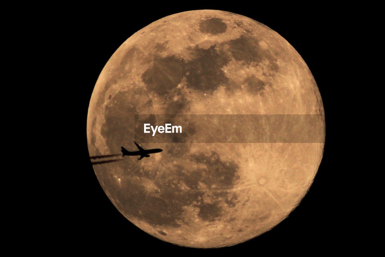 Low angle view of moon against sky at night