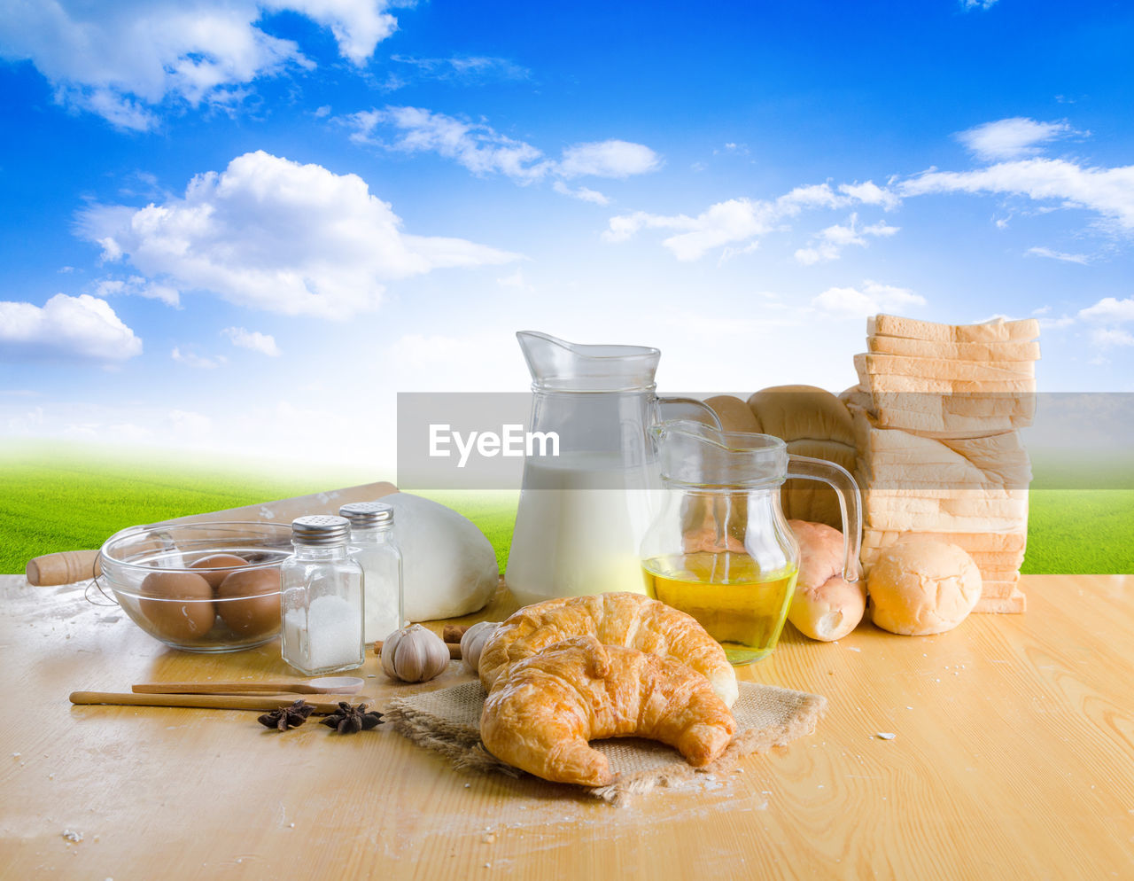 High angle view of croissant and ingredients on table against sky