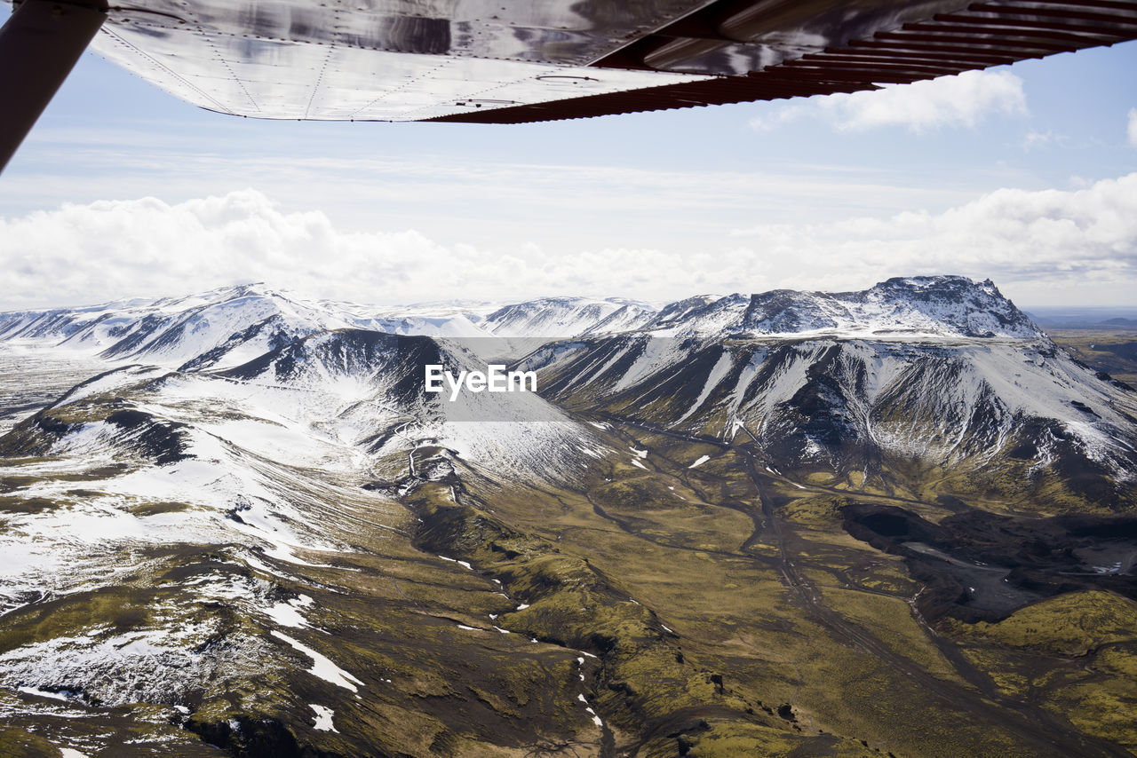 Aerial view of icelandic mountains from airplane wing pov