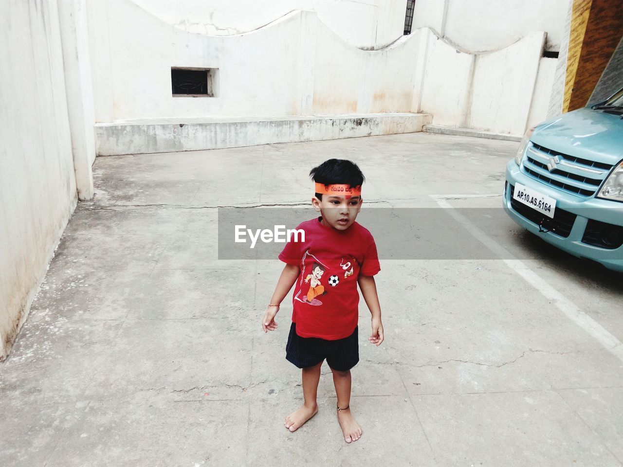 PORTRAIT OF BOY STANDING ON FLOOR