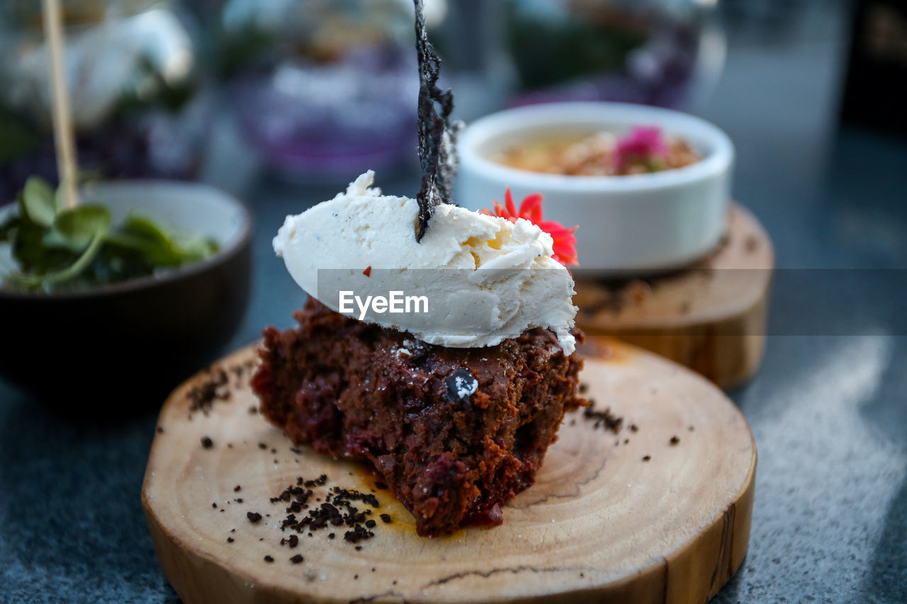 CLOSE-UP OF CAKE WITH ICE CREAM ON PLATE