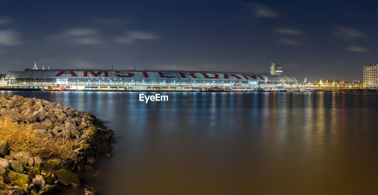 VIEW OF ILLUMINATED CITY AT NIGHT