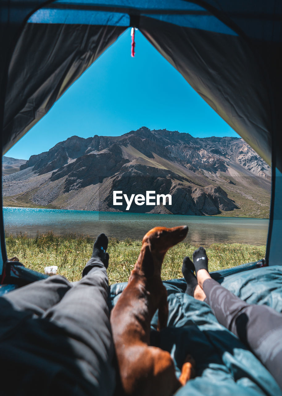 LOW SECTION OF MAN LYING IN MOUNTAINS