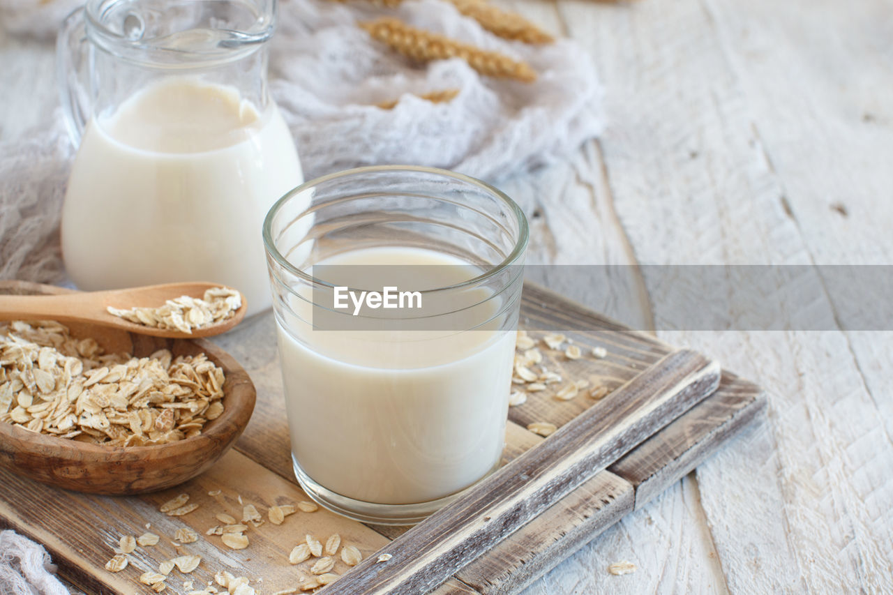 High angle view of oat flake with milk on wooden table