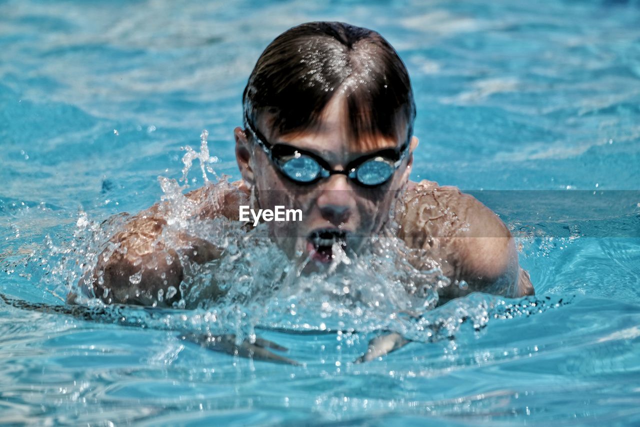 Close-up of man swimming in pool