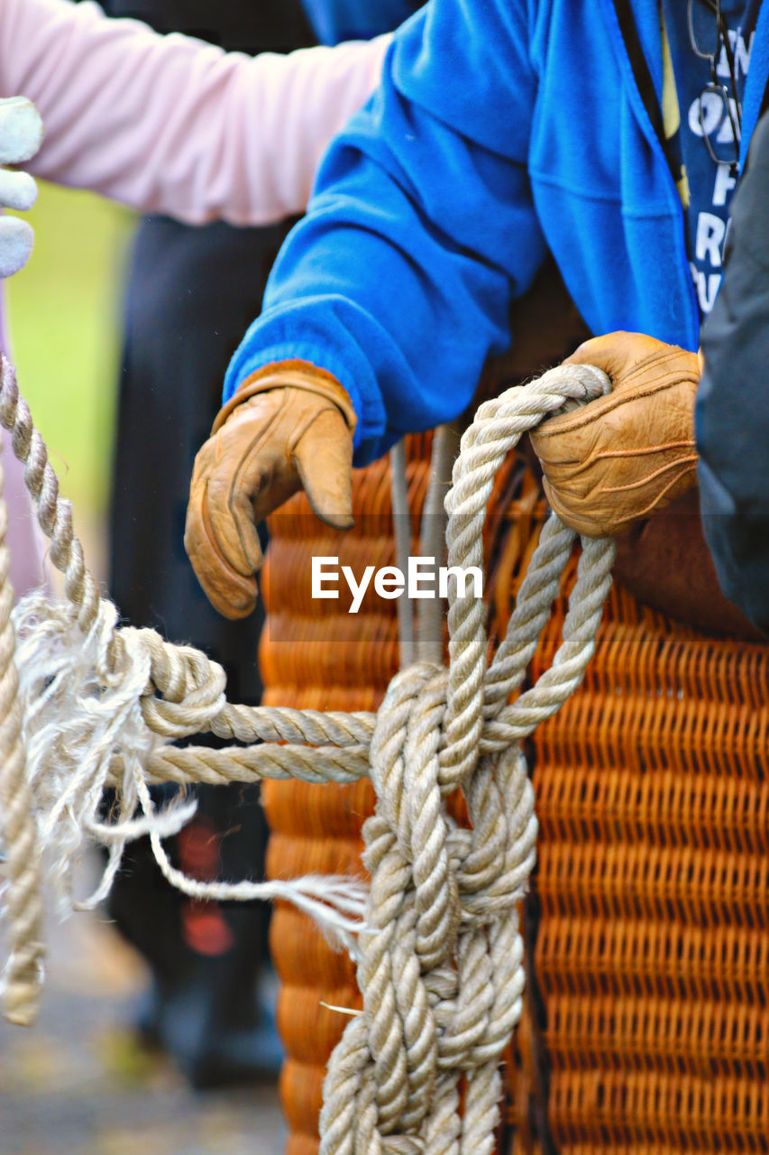 Close-up of man tied up rope hot air balloon 