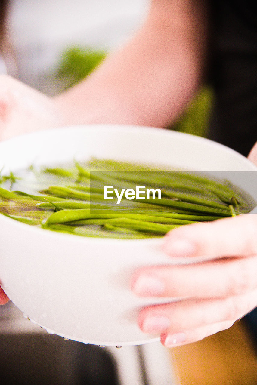 Close-up of hand holding bowl