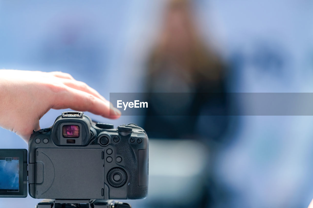 cropped hand of person holding camera