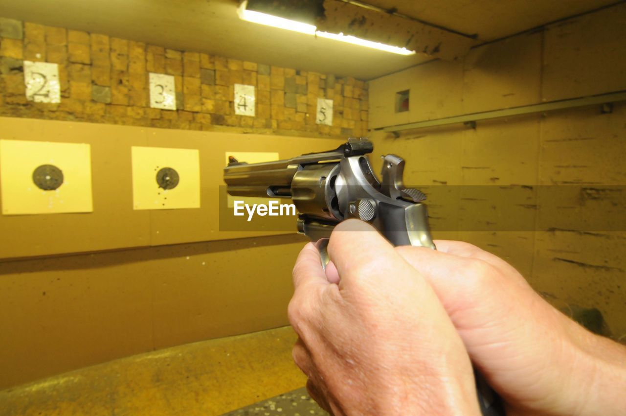 Target shooter at a shooting range, indoor sports with weapon