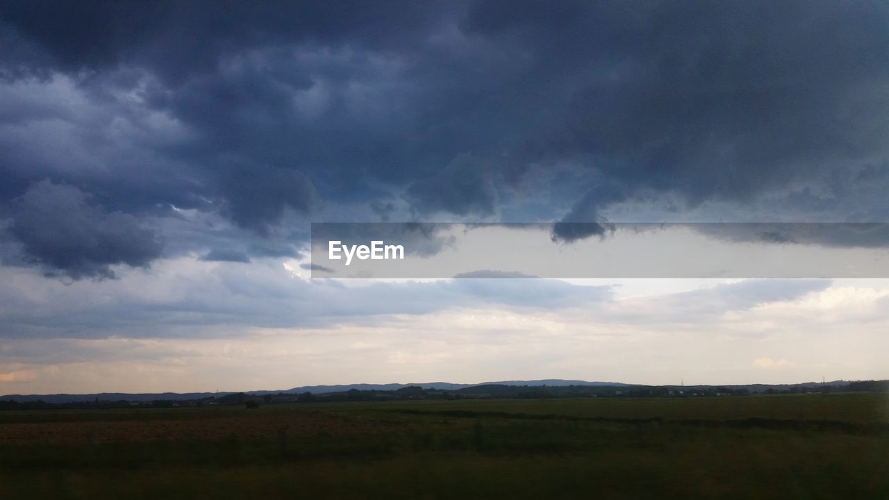 SCENIC VIEW OF LANDSCAPE AGAINST CLOUDY SKY