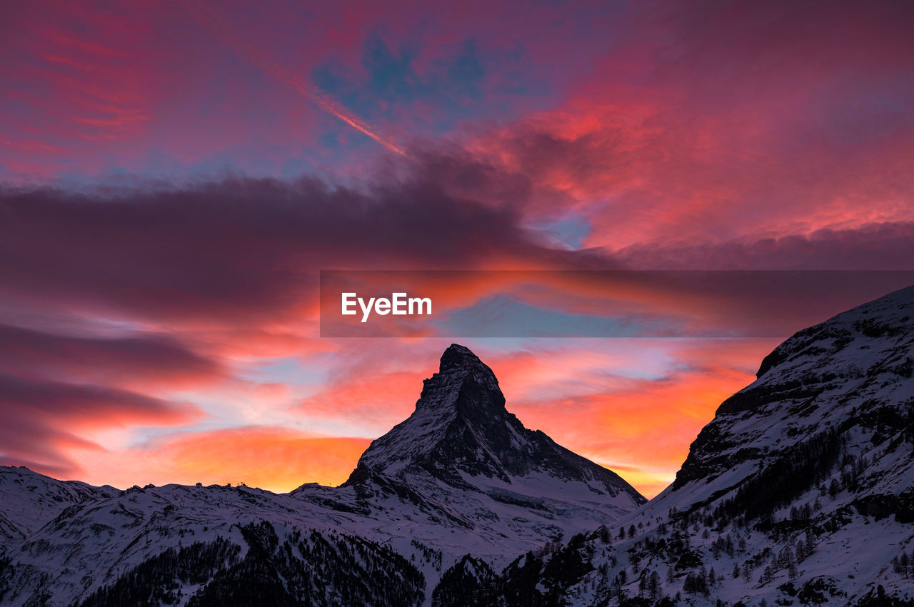 SCENIC VIEW OF MOUNTAINS AGAINST SKY DURING SUNSET