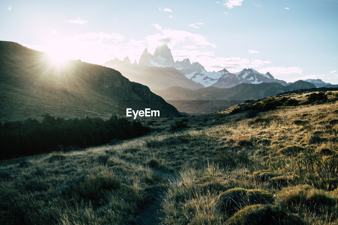 Scenic view of snowcapped mountain peak against sunset sky