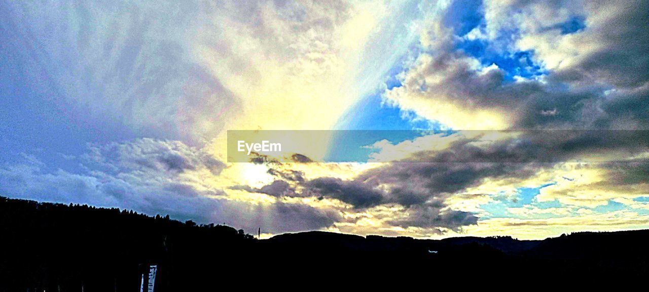 sky, cloud, beauty in nature, scenics - nature, nature, mountain, tranquility, no people, silhouette, dramatic sky, tranquil scene, environment, sunlight, sunset, landscape, horizon, idyllic, outdoors, low angle view, mountain range, evening, dusk