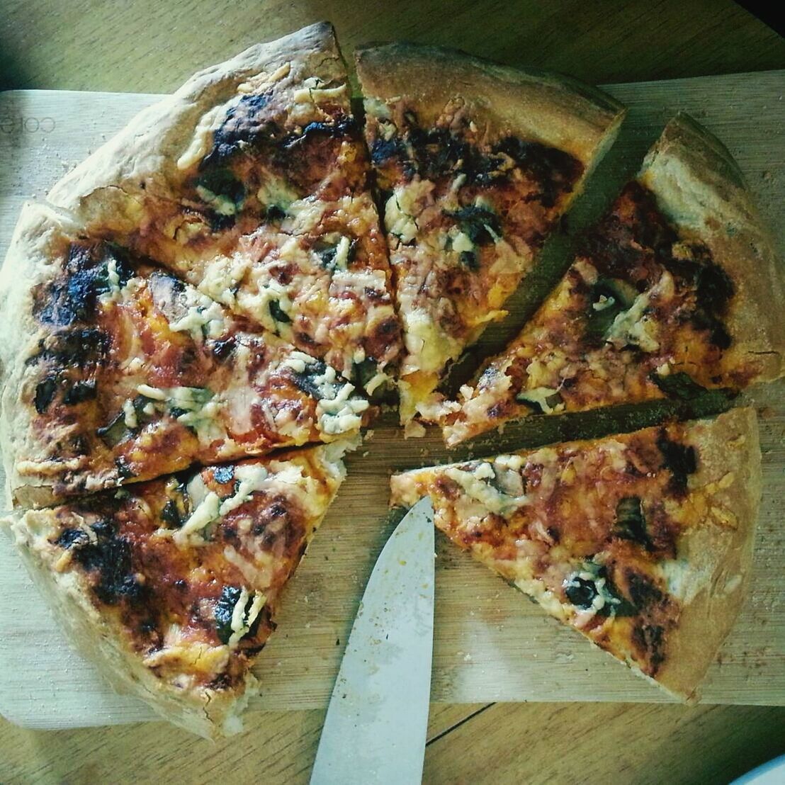 High angle view of pizza slices on cutting board