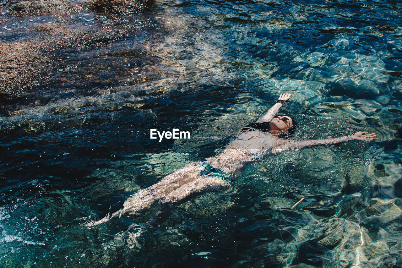 High angle view of woman swimming in sea