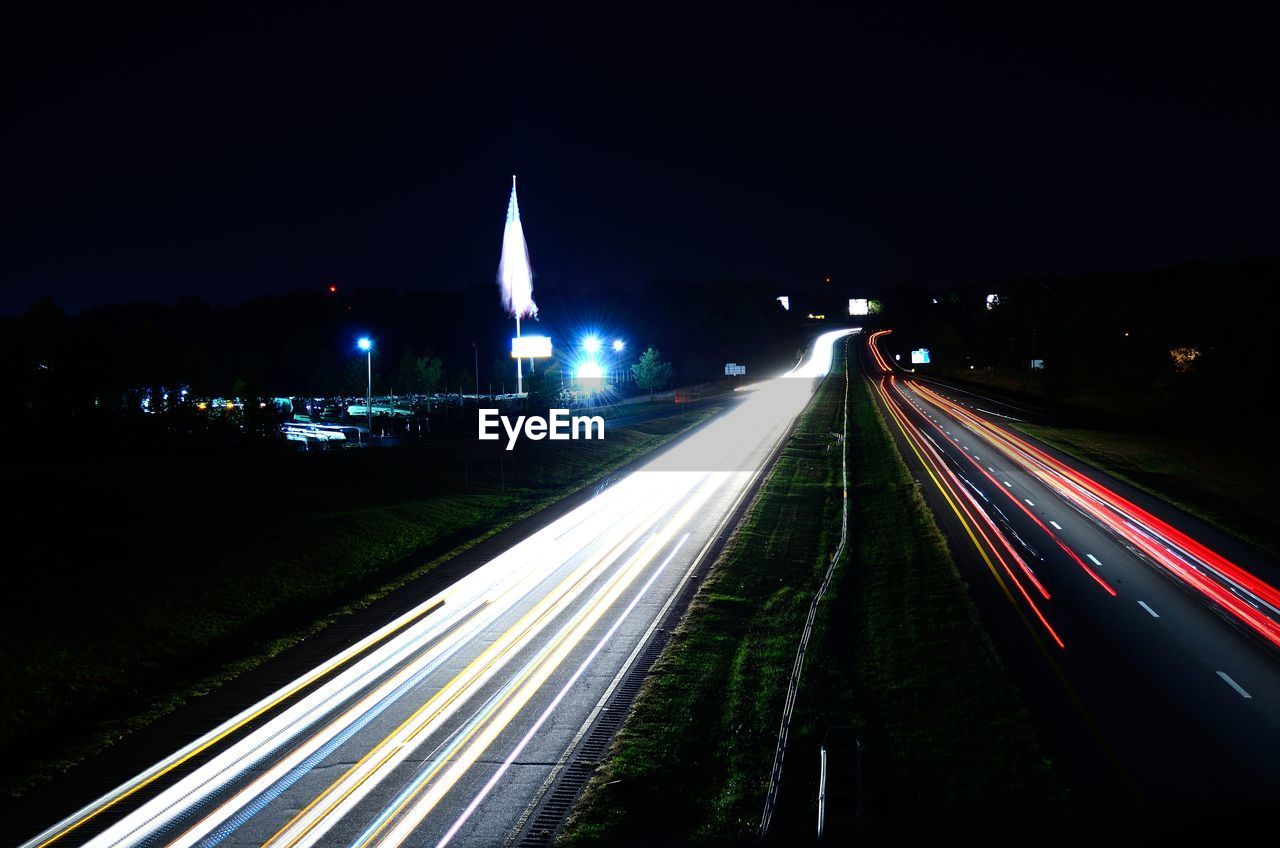 High angle view of light trails on road at night